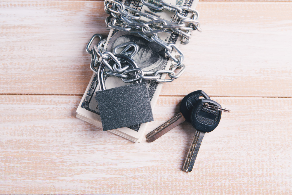 Money secured with a chain and padlock, next to keys on a wooden surface. Turn Key Locksmith, Phoenix AZ