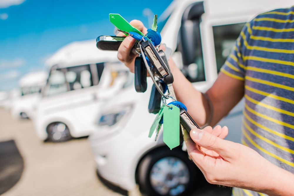 Holding RV keys in front of a white camper van. Turn Key Locksmith, Phoenix AZ
